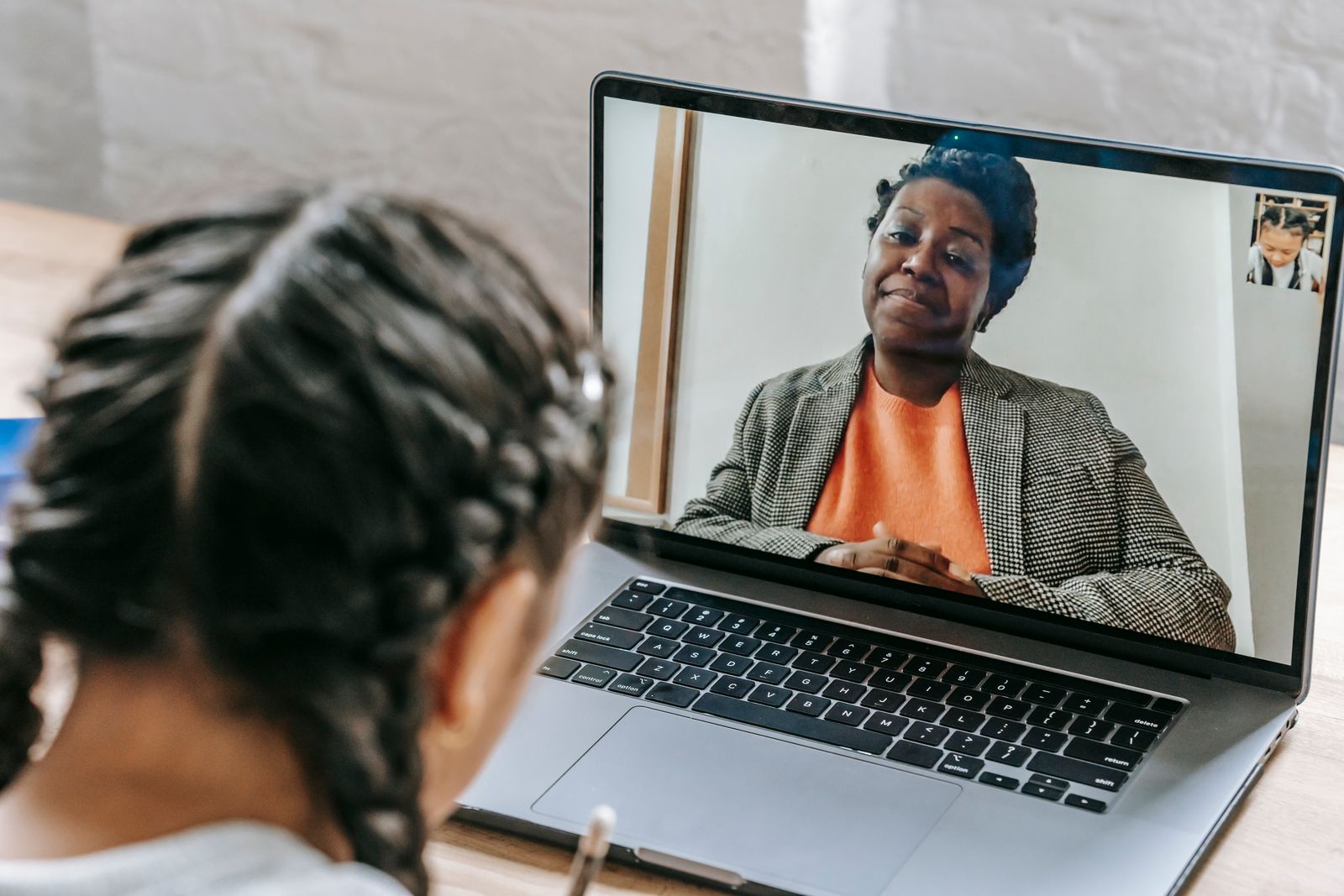 Student taking an online lesson with a tutor on a laptop